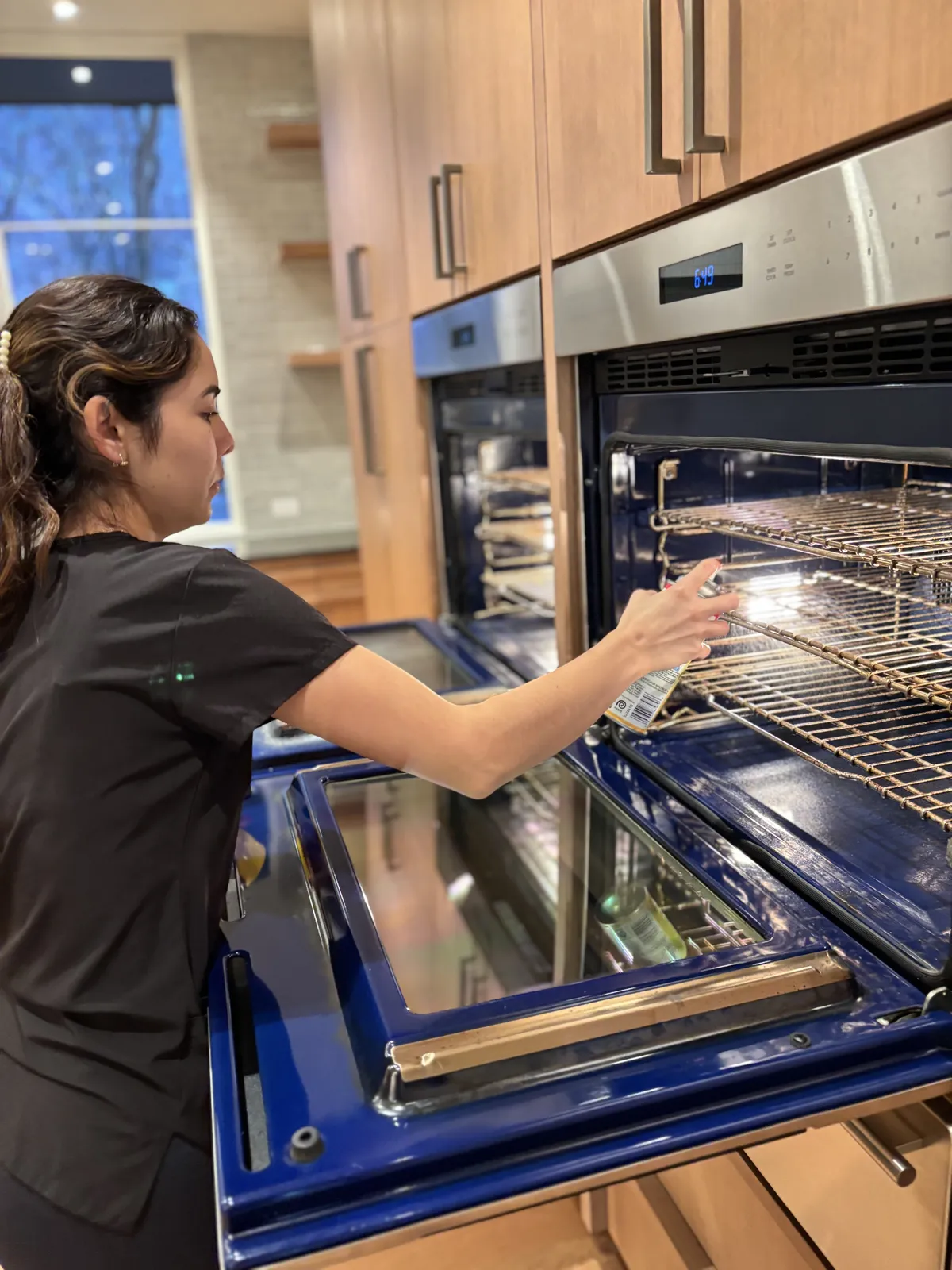 Fresh Start crew member spraying and detailing the interior of a wall oven during a Nashville kitchen deep clean