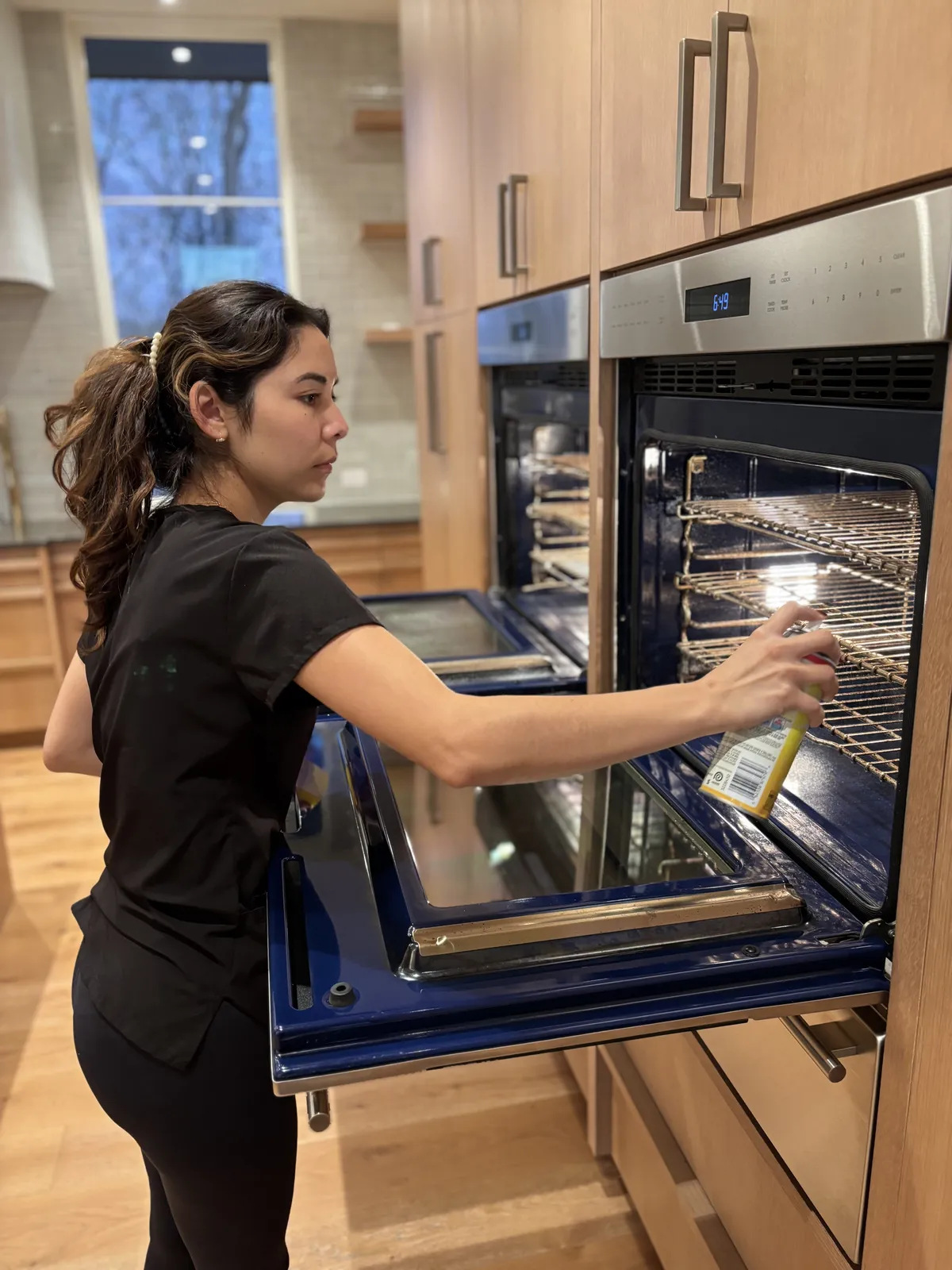 Fresh Start crew member cleaning an oven interior for a deposit-ready move-out in Nashville