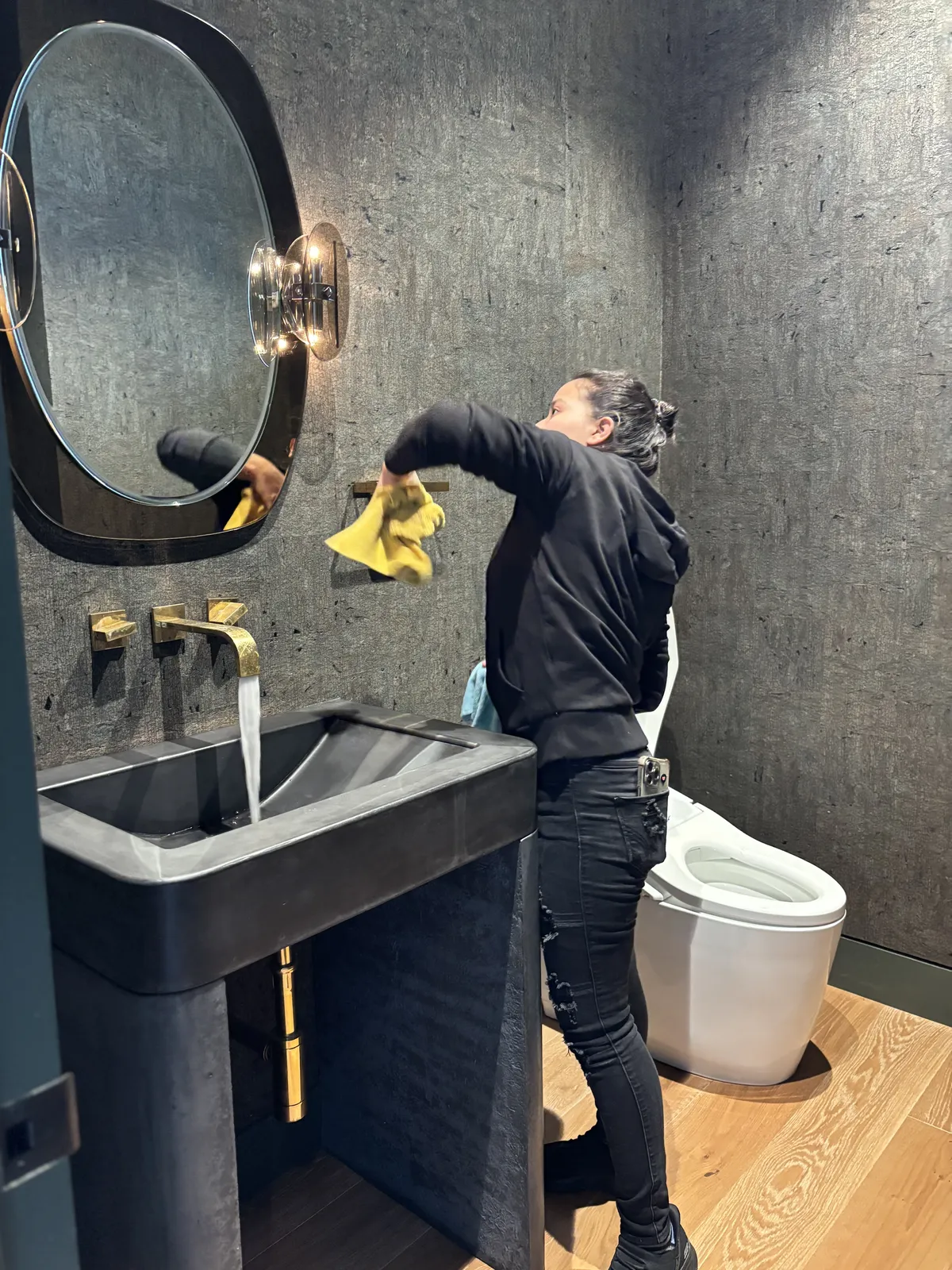 Fresh Start crew member polishing a mirror during a deep clean in a Nashville home
