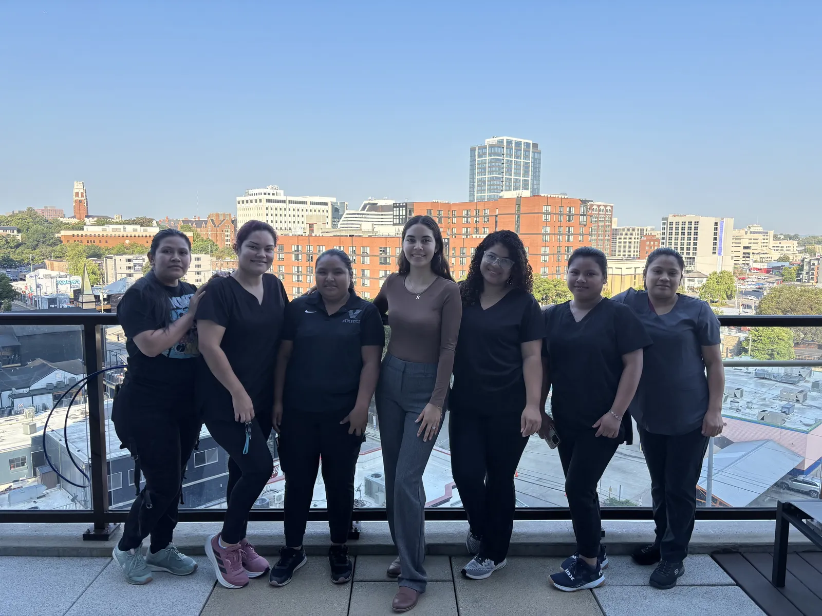 The Fresh Start Cleaning crew together on a Nashville rooftop with the downtown skyline behind them