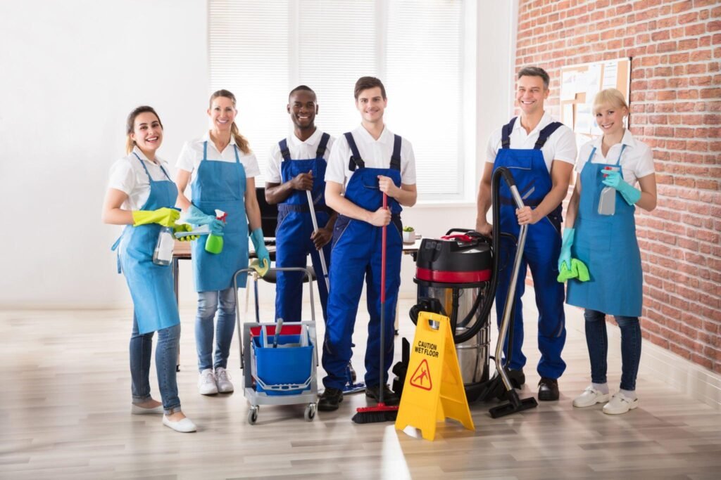 Professional cleaning team with equipment ready for apartment cleaning