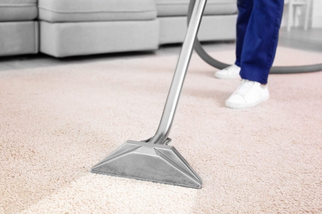Vacuuming carpet with professional extraction equipment