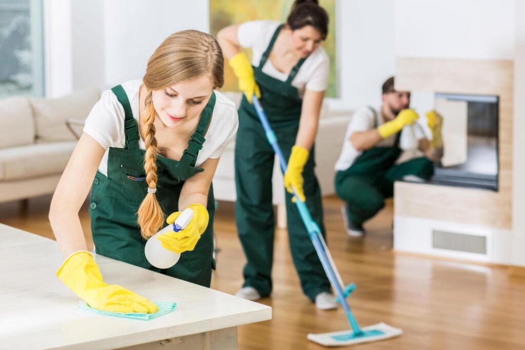 Cleaning crew wiping and mopping living room during janitorial service