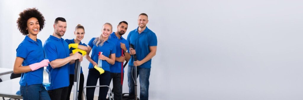 Professional cleaning team in blue uniforms with equipment