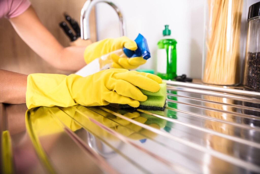 Wiping kitchen sink and faucet during standard cleaning visit